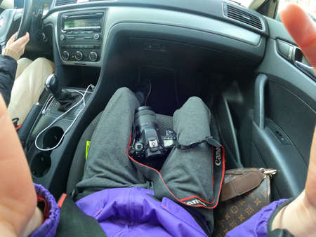 Ukraine Dnepr 10.04.2021 - The Canon 80d camera lies on the legs of the girl in the car, the photo was taken by GoPro Hero9, the photographer in the carのeditorial素材