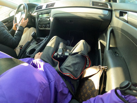 Ukraine Dnepr 10.04.2021 - The Canon 80d camera lies on the legs of the girl in the car, the photo was taken by GoPro Hero9, the photographer in the carのeditorial素材