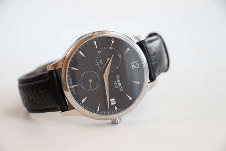 Ukraine Dnipro 10.04.2021 - old mens watch tissot lie on a white background in daylight close-up