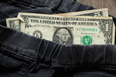 dollar bills lie on black denim close-up, dollars