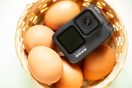 Ukraine Dnipro 04/14/2021 - GoPro Hero 9 lies in boxes with chicken eggs, new technologiesのeditorial素材