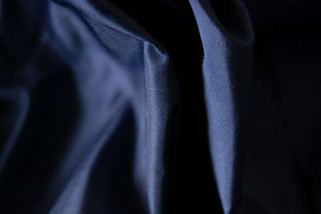dark blue fabric wrinkled as background close-upの写真素材