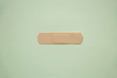 medical brown plaster lies on colored paper close-upの写真素材