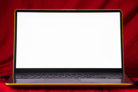 laptop with white screen on red background close up
