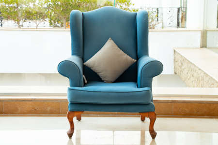 blue soft armchair in the lobby in the living room of a hotel in egypt laid the windows in the sun