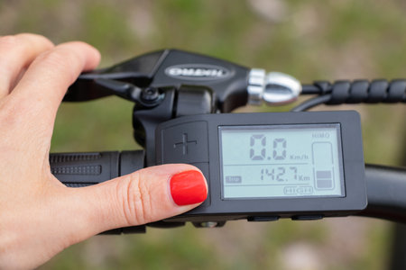 Ukraine Dnipro 08.05.2021 - display with buttons and speed switches and a battery charge sensor on the handlebars of an electric bike, an electric bikeのeditorial素材