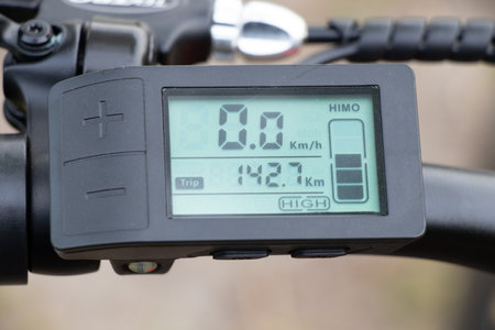 Ukraine Dnipro 08.05.2021 - display with buttons and speed switches and a battery charge sensor on the handlebars of an electric bike, an electric bikeのeditorial素材