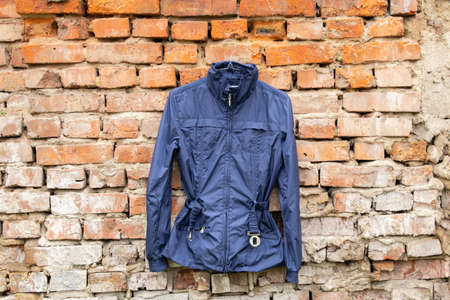 blue womens jacket weighs on hangers on the wall at home outdoors, womens jacket fashion