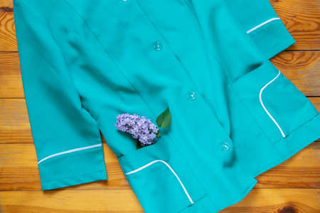 an old nurse's suit lies on a wooden table, the uniform of a medical worker in Ukraine, a doctor's uniformの写真素材