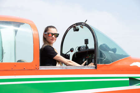 a girl driving a four-seater plane at an airfield in Ukraine in the city of Dnipro, driving an airplaneの写真素材
