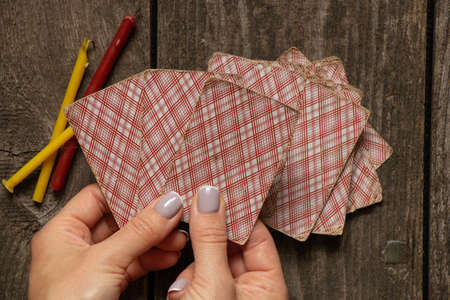 cards in the hands of a fortune teller and candles on the table, fortune teller with cards, fortune...