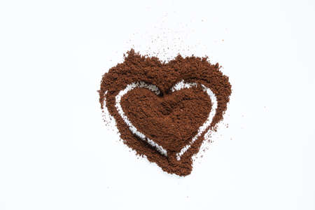 sprinkled coffee on a white background in the form of a heart, coffee backgroundの写真素材