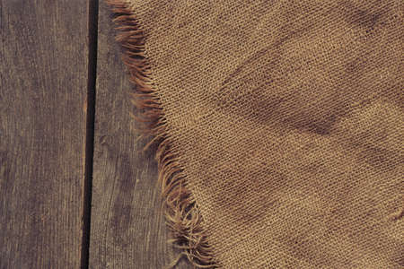 burlap lies on an old wooden floor for background, wooden background with fabricの写真素材