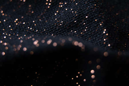 black fabric with shiny splashes in blurred focus, macro photoの写真素材