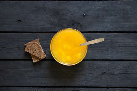 vegetable pea soup and a slice of black bread on a black wooden table in the kitchen, soup without meatの写真素材