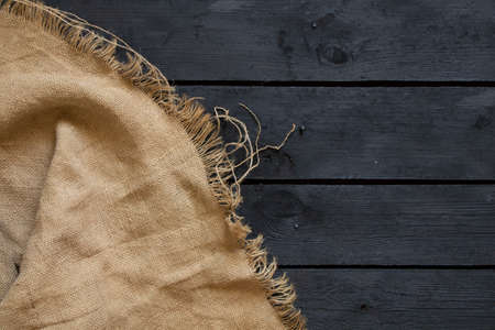 black wood board and brown fabric as background, rag on the floor, wood backgroundの写真素材