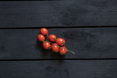 cherry tomatoes on black wooden background, tomatoの写真素材