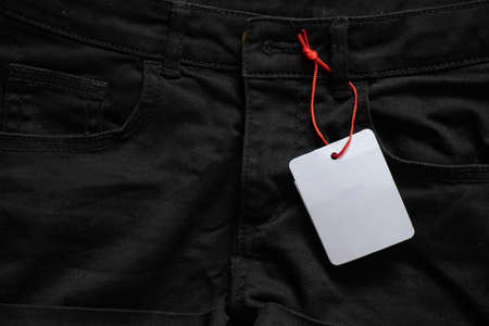 womens denim shorts with white blank paper price tag for text on table, price tag on shorts, place for priceの写真素材