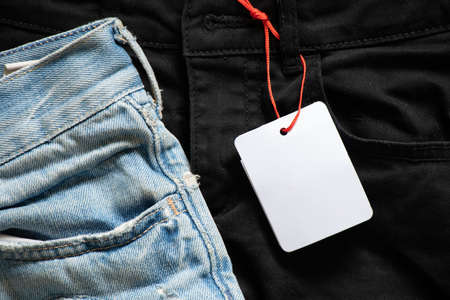 womens denim shorts with white blank paper price tag for text on table, price tag on shorts, place for priceの写真素材