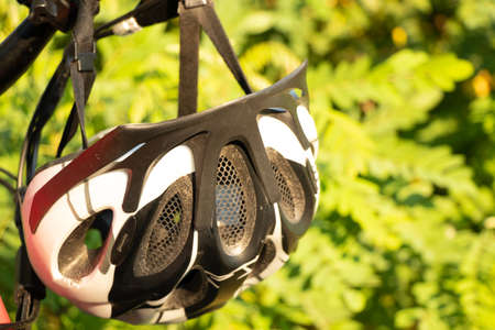 bicycle helmet on the handlebars of an e-bike at sunset in nature, cycling helmet on a bicycleの写真素材
