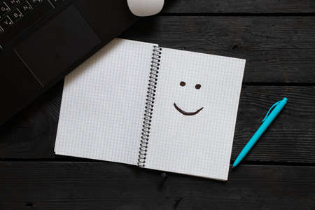 a smile drawn in a notebook on a desk during work, a good moodの写真素材