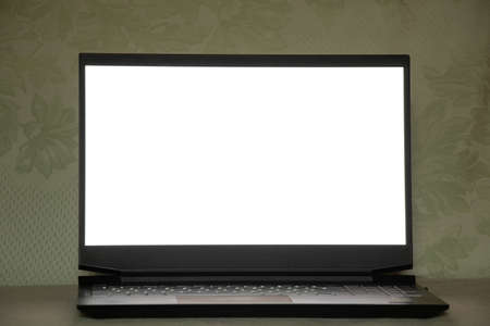 black laptop with white screen stands on the kitchen on the table at home, laptop with white screen,...