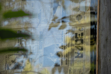 Ukraine Dnipro 07/31/2021 - the old Russian newspaper Zarya is glued to the window glass from the suns in the apartment, the old Soviet Russian newspaperのeditorial素材