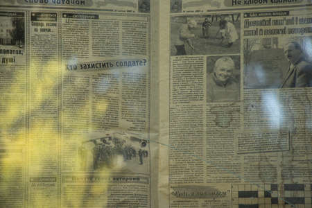 Ukraine Dnipro 07/31/2021 - the old Russian newspaper Zarya is glued to the window glass from the suns in the apartment, the old Soviet Russian newspaperのeditorial素材