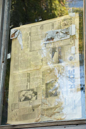 Ukraine Dnipro 07/31/2021 - the old Russian newspaper Zarya is glued to the window glass from the suns in the apartment, the old Soviet Russian newspaperのeditorial素材