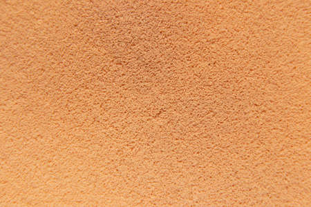 beige powder coat as a background macro photo, beige background sponge, tonal powderの写真素材