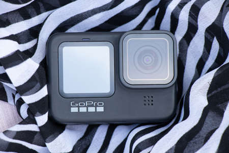 Ukraine Dnipro 08/05/2021 - GoPro HERO 9 camera on a striped background on the beach, an action camera on a striped fabricのeditorial素材