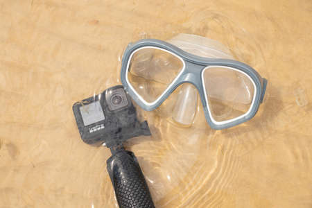 Ukraine Dnipro 08/05/2021 - Camera and mask GoPro HERO 9 for diving on the beach in the water by the lake, action camera on the lakeのeditorial素材