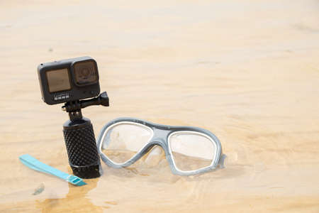 Ukraine Dnipro 08/05/2021 - Camera and mask GoPro HERO 9 for diving on the beach in the water by the lake, action camera on the lakeのeditorial素材