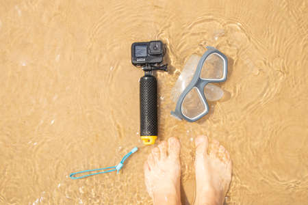 Ukraine Dnipro 08/05/2021 - Camera and mask GoPro HERO 9 for diving on the beach in the water by the lake, action camera on the lakeのeditorial素材