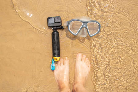 Ukraine Dnipro 08/05/2021 - Camera and mask GoPro HERO 9 for diving on the beach in the water by the lake, action camera on the lakeのeditorial素材
