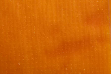 piece of hard cheese as background close-up, yellow gray backgroundの写真素材