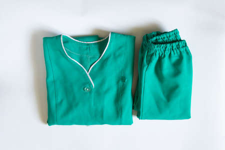 an old doctor's medical suit lies on a white background, a medical uniform in a crutch, work clothesの写真素材