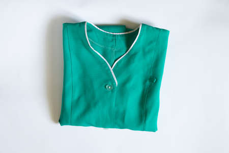 an old doctor's medical suit lies on a white background, a medical uniform in a crutch, work clothesの写真素材