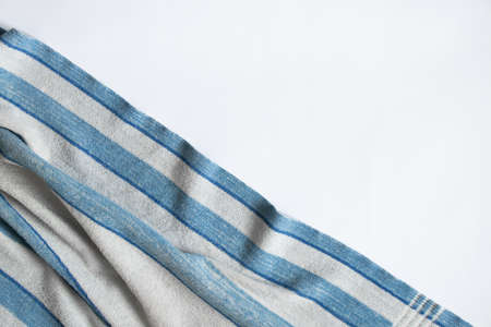 blue towel folded lies on a white background, bath blue towel on an isolated backgroundの写真素材