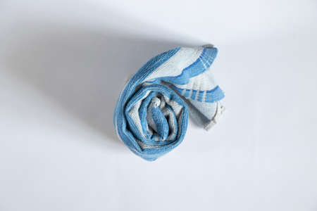 blue towel folded lies on a white background, bath blue towel on an isolated backgroundの写真素材