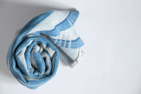 blue towel folded lies on a white background, bath blue towel on an isolated backgroundの写真素材