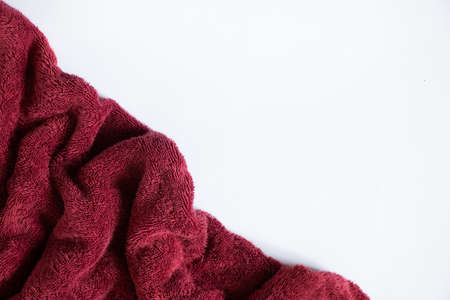red towel folded lies on a white background, bath red towel on an isolated backgroundの写真素材