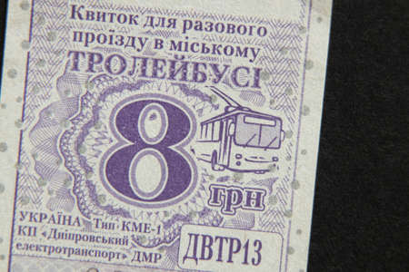 Ukraine Dnipro 12.08.2021 - paper trolleybus ticket for 8 hryvnia one-time travel, the ticket lies on a black backgroundのeditorial素材
