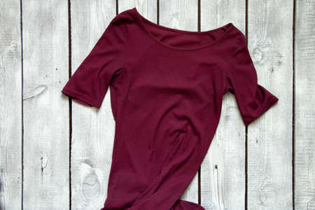 red long dress lies on a white wooden table, dress fashionの写真素材