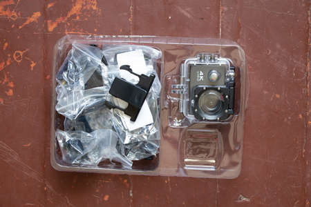 Ukraine Dnipro 08.24.2021 -Action camera and accessories in a box packed on the table, a new cameraのeditorial素材