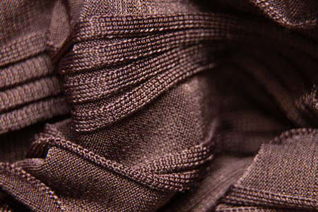 brown wrinkled silk fabric close up, wrinkled satin fabric as backgroundの写真素材