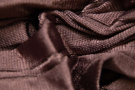 brown wrinkled silk fabric close up, wrinkled satin fabric as backgroundの写真素材