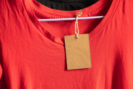 cardboard, packaging, casual, clothing, branding, shopping, brown paper price tag weighs on clothes on a rack on a hanger in the sales area, blank price tag on clothesの写真素材