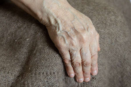 hand of an old woman on a blanket close-up, hands, pensioner, old handsの写真素材