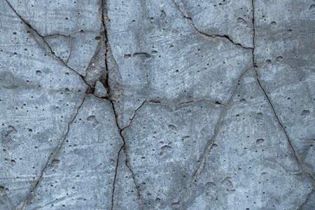 dry concrete cracked wall as background, concrete wall, gray backgroundの写真素材